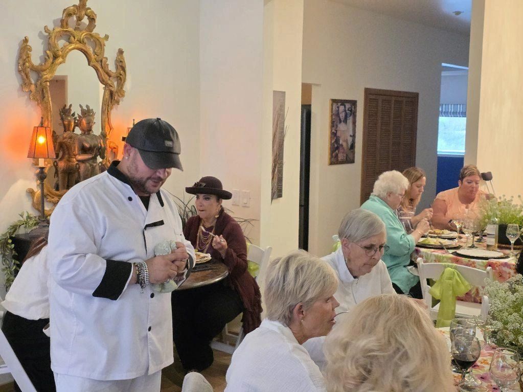 Chef Joshua Preston serving guests at an elegant dinner event